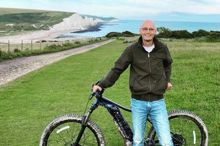 a man holding a bicycle