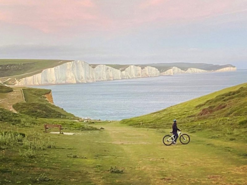 a close up of a hillside next to a body of water