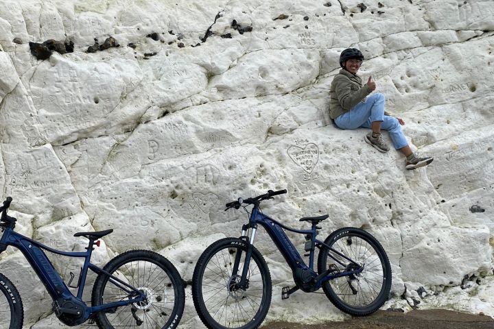 a man riding on the back of a bicycle