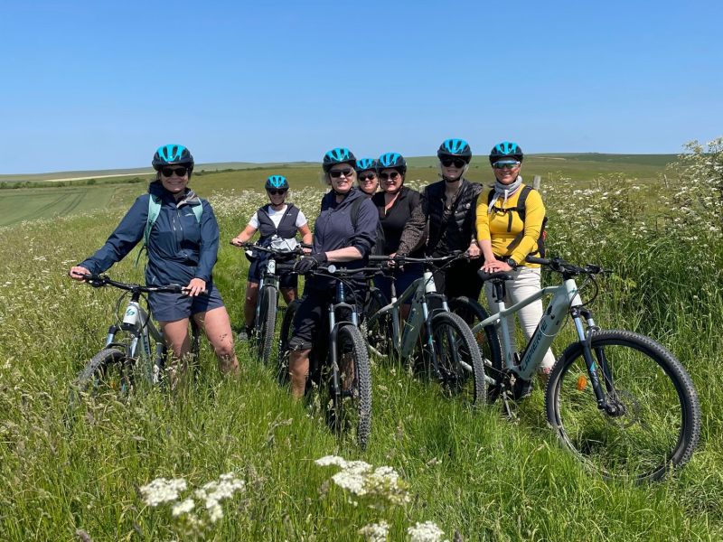 a group of people standing next to a bicycle