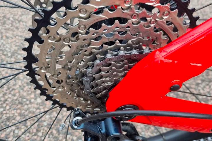 Close-up of a bicycle's rear cassette and red frame.